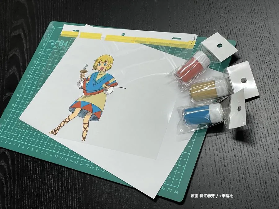 カッティングマットの上で、生セルにアニメカラーを塗っているところ